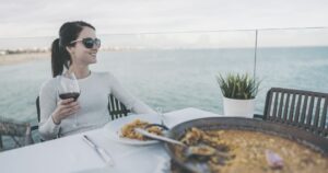 Woman enjoying food oceanside